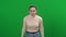 Stressed angry young woman screaming at chromakey background looking at camera. Portrait of furious overwhelmed