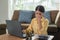 Stressed Asian business woman working on a laptop at her house, working at home, business concept