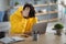 Stressed Asian male sitting at desk with pc