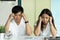 Stressed asian young couple looking at issues notification from bank about late payment home loan.