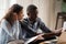 Stressed black couple with bills and laptop at home