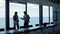 Stressed business partners argue contract papers at beautiful panorama window