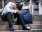 Stressed businessman sitting at stairway outdoor.Bankrupt businessman sitting outdoor.