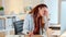 Stressed businesswoman suffering from a headache while working on a desktop computer at work. Unhappy female suffering