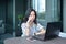 Stressed Casual Business Asian Woman using a laptop in condo, ge