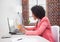 Stressed casual businesswoman sitting at desk