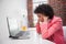 Stressed casual businesswoman sitting at desk