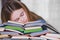 Stressed college student tired of hard learning with books in exams tests preparation