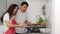 Stressed couple conflict in their kitchen while cooking and preparing food