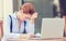 Stressed displeased worried business woman sitting in front of laptop computer