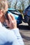 Stressed Driver Sitting At Roadside After Traffic Accident