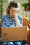 Stressed elegant woman with laptop at modern home in sunny day