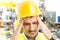 Stressed factory worker suffering head pain migraine or headache