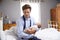 Stressed Father Dressed For Work Holding Baby In Bedroom