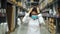 Stressed female manager with medical mask in warehouse store during coronavirus covid-19 pandemic