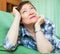 Stressed female pensioner on couch