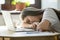 Stressed female sleeping at office desk