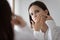 Stressed frowning teenage girl focused on beauty care problem