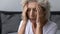 Stressed frustrated elderly woman feeling strong painful headache