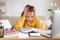 Stressed little girl doing homework at home