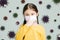 Stressed little girl wearing Protection Mask against flu virus  background