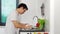 Stressed man washing vegetables in the sink in the kitchen at home