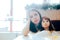 Stressed Mom Sitting with her Child in a Restaurant Booth