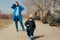 Stressed Mother Supervising Child Playing Outdoors