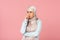 Stressed muslim girl in hijab, isolated on pink