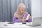 Stressed muslim woman calculating monthly financial, plan budget on computer, pay bills or taxes online at home.