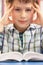 Stressed Schoolboy Studying In Classroom