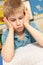 Stressed Schoolboy Studying In Classroom