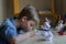 Stressed schoolboy studying at home during quarantine.