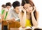 Stressed Schoolgirl Studying In Classroom