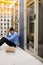 Stressed technician sitting in hallway