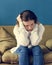 Stressed teenager sitting on a sofa