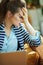 Stressed trendy woman with laptop in modern house in sunny day