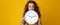 Stressed trendy woman on yellow background biting clock