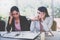 Stressed, unhappy female worker in the office with various problems with a worried look on her friend.