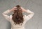 Stressed woman against cracked stone wall