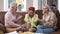 Stressed woman closing ears with hands as angry friends yelling sitting on couch on both sides. Portrait of frustrated