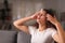 Stressed woman drying sweat in a warm night at home