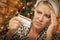 Stressed Woman Holding Credit Card In Front of Christmas Tree