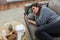 stressed woman with smartphone on sofa at home