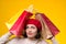 Stressed woman tired of shopping. Young woman in beret among shopping bags. Seasonal sales, shopping concept. Woman after shopping