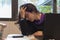 Stressed woman at work into office in front of the notebook. Burn out syndrome concept