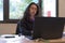 Stressed woman at work into office in front of the notebook. Burn out syndrome concept