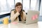 Stressed woman working with laptop computer on desk in overworked