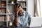 Stressed young african american man touching forehead, suffering from headache.