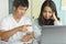 Stressed young asian couple looking at issues notification from bank about late payment home loan credit